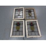 Four stained leaded glass windows in frames.