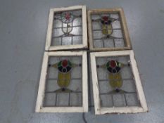 Four stained leaded glass windows in frames.