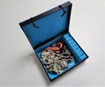 A Chinese style jewellery box containing costume jewellery, beaded necklaces,
