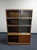 A 20th century Minty four tier sliding glass door stacking bookcase.