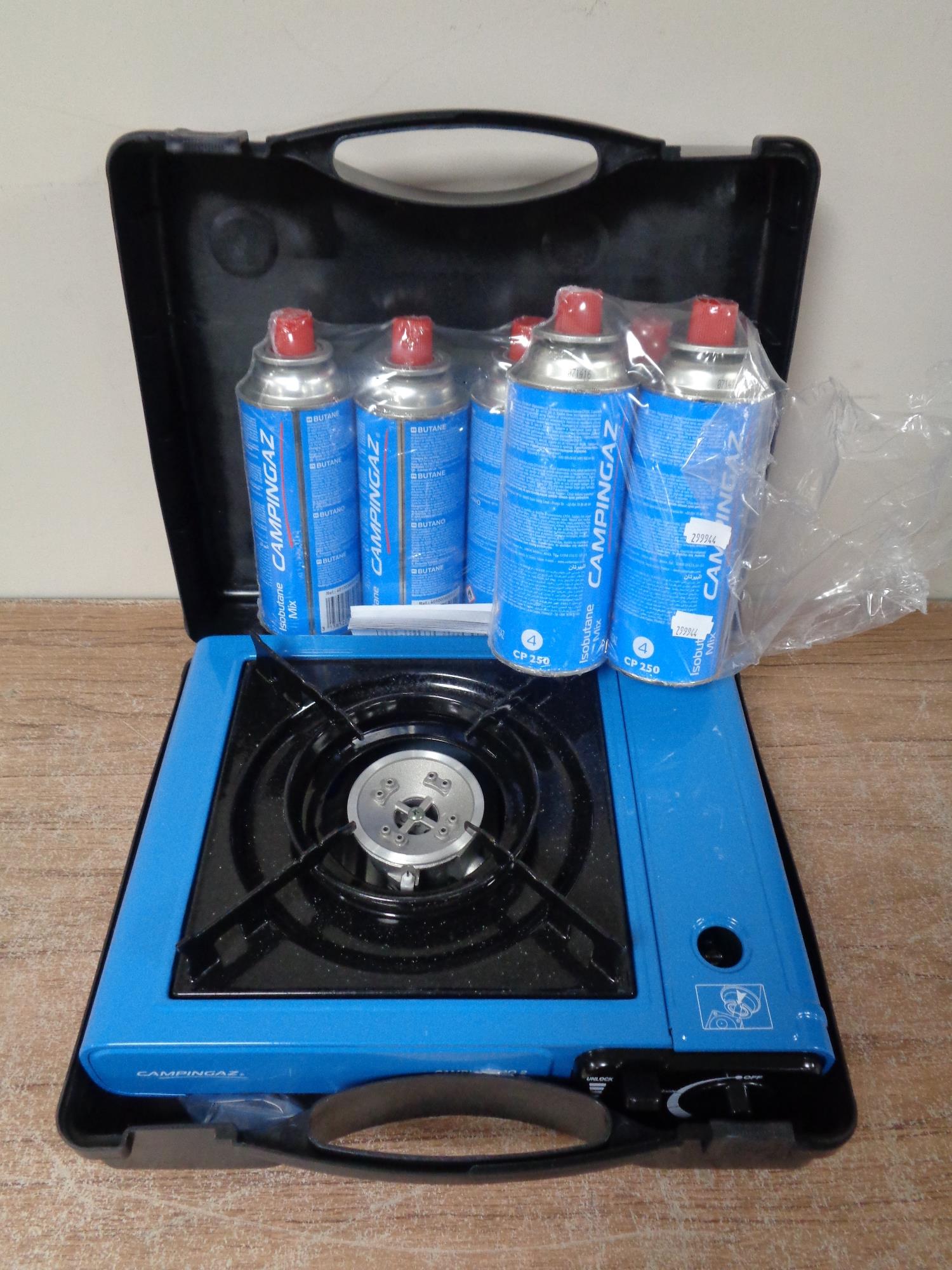 A portable gas stove together with six canisters