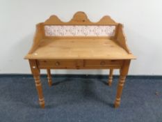 A pine tiled back wash stand, fitted two drawers.