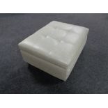 A contemporary oversized footstool