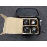 A luggage case containing four Greenmaster bowls together with chalks,