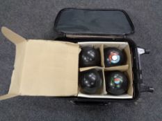 A luggage case containing four Greenmaster bowls together with chalks,