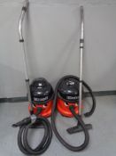 Two Edward 110V commercial vacuums with hoses and accessories.