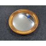 An early twentieth century gilt framed composite porthole mirror