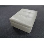 A contemporary oversized footstool