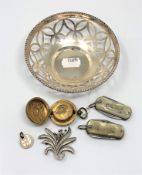 A brass sovereign case, a silver brooch, a silver plated pierced bowl,