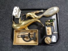 A tray containing a boxed Student microscope, brass figure of dolphins, plated backed hairbrush,