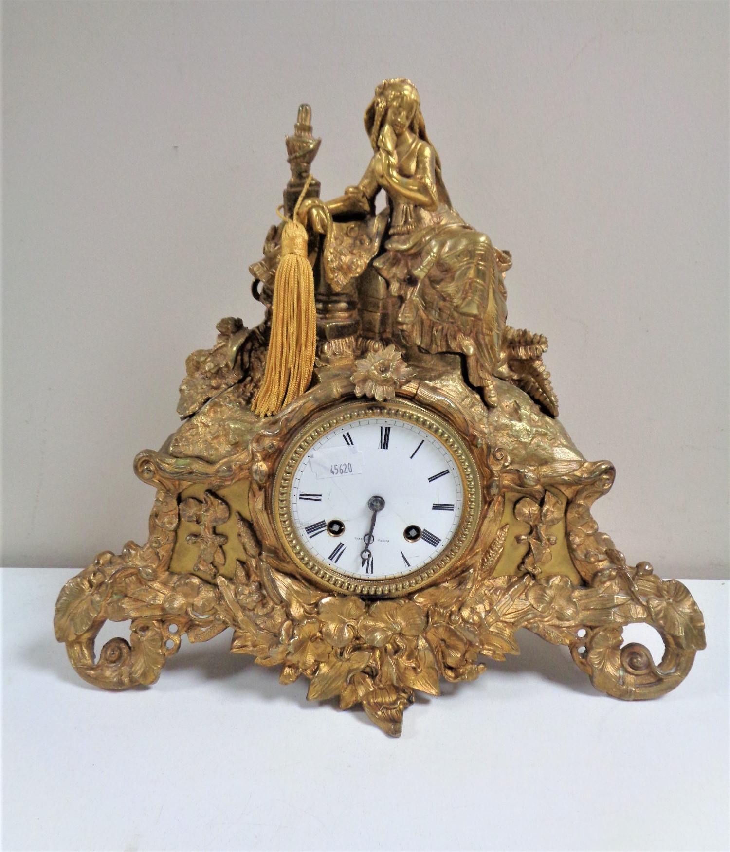 An antique French gilt mantel clock signed Laine A Paris, with enamelled dial,