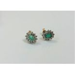 A pair of 9ct gold emerald cluster earrings. CONDITION REPORT: 1.