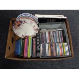 A box containing miscellaneous to include decorative wall plates, assorted books, CDs etc.