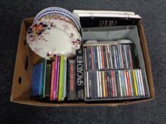 A box containing miscellaneous to include decorative wall plates, assorted books, CDs etc.