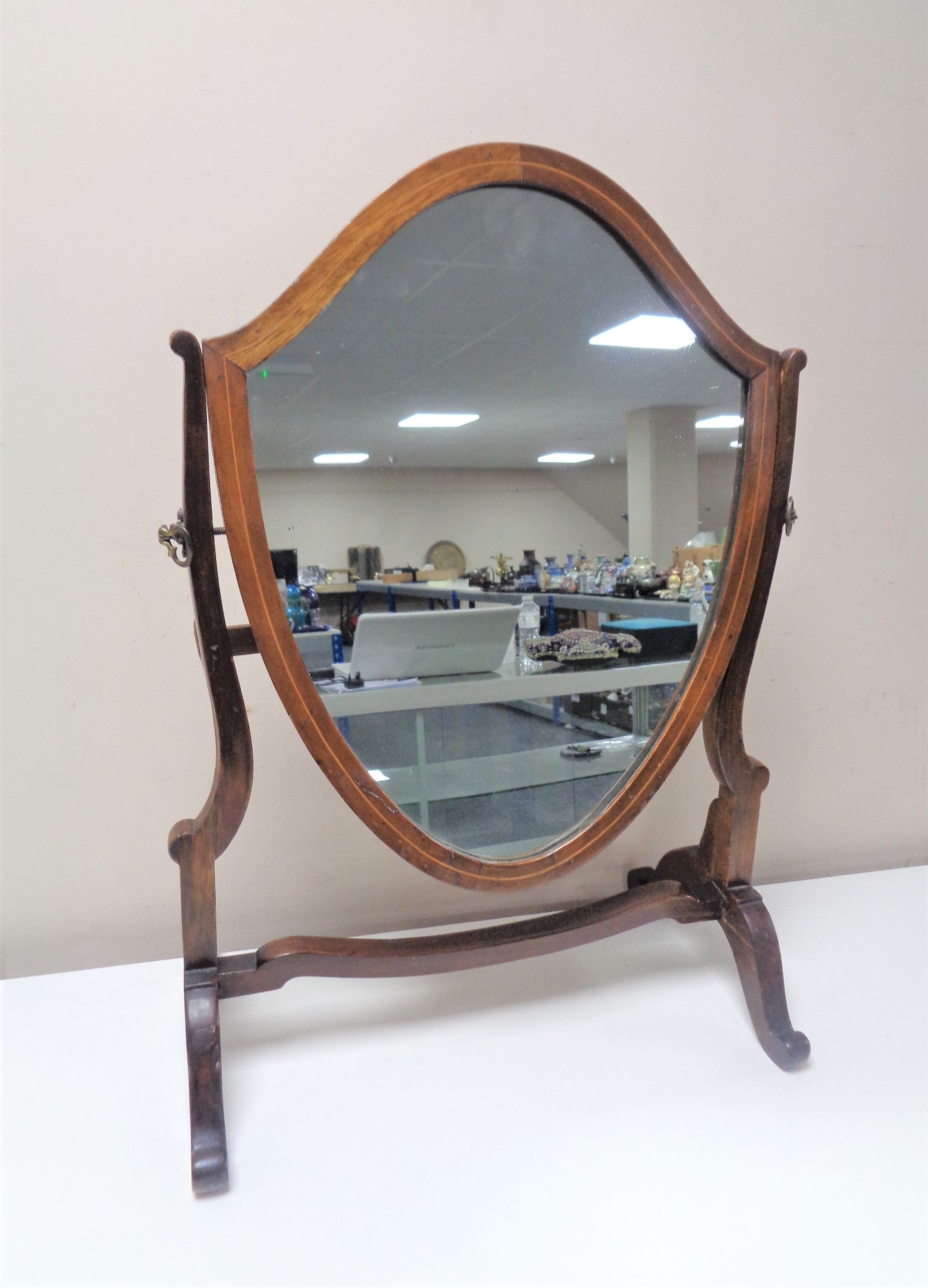 A Victorian mahogany shield dressing table mirror