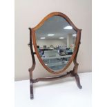 A Victorian mahogany shield dressing table mirror