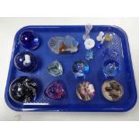 A tray of assorted glass paperweights, Caithness moon crystal and pebble,