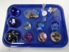 A tray of assorted glass paperweights, Caithness moon crystal and pebble,