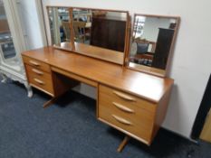 A mid 20th century teak Austin suite kneehole dressing table with triple mirror (A/F).