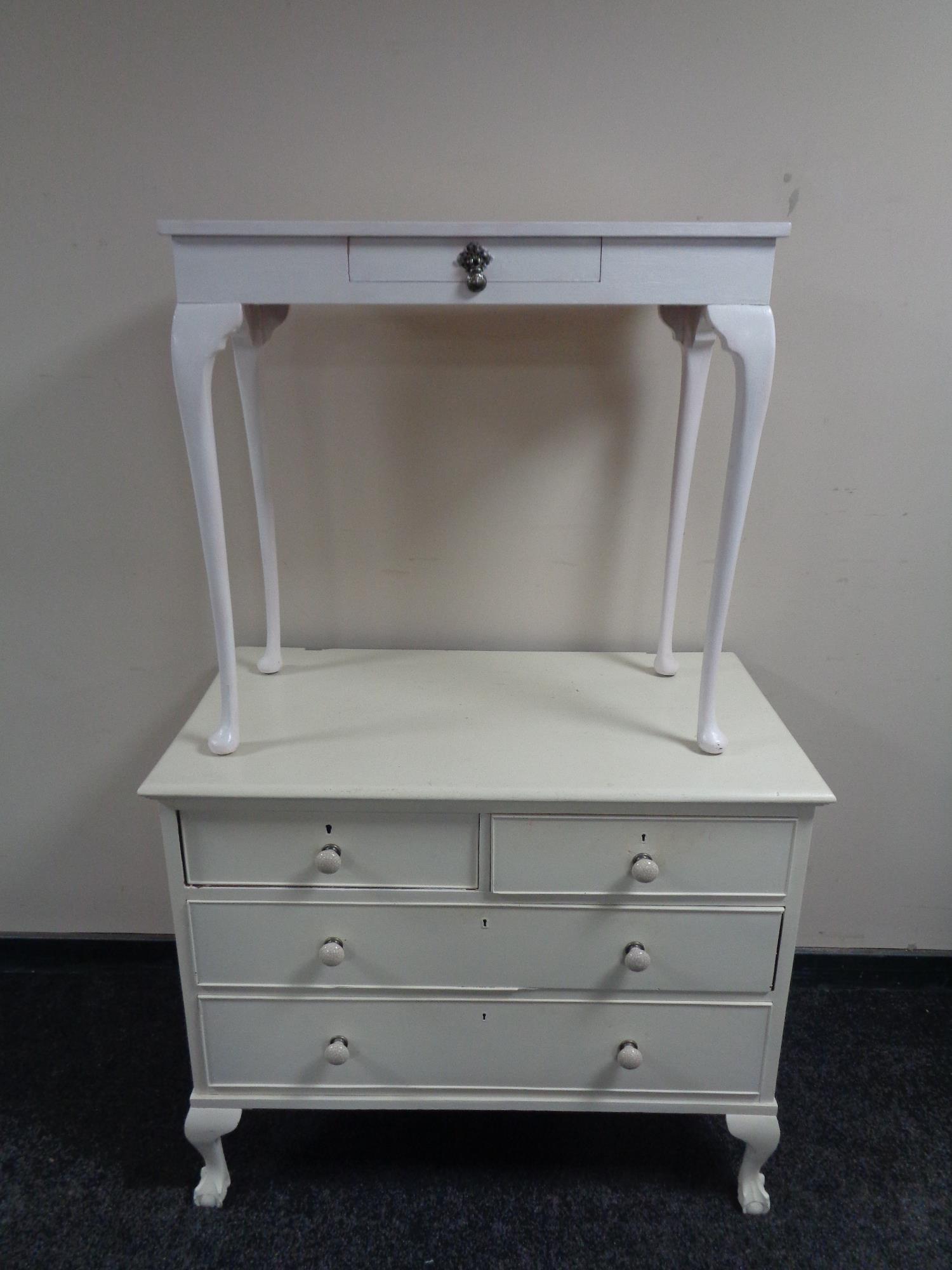 A painted Edwardian four drawer chest on claw and ball feet with ceramic handles,