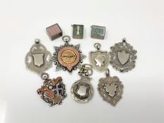 Seven various silver fobs, together with three small silver charms.