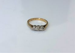An 18ct gold three stone diamond ring, size K. CONDITION REPORT: 2.