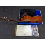 A crate containing Spanish acoustic guitar, laptop bag, mini dehumidifier etc.