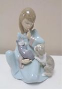 A Lladro figure of a girl seated with puppy and cat number 5640