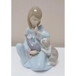 A Lladro figure of a girl seated with puppy and cat number 5640