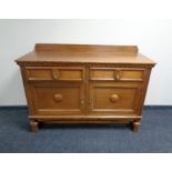 An Edwardian oak double door sideboard, fitted two drawers.