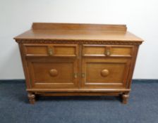 An Edwardian oak double door sideboard, fitted two drawers.