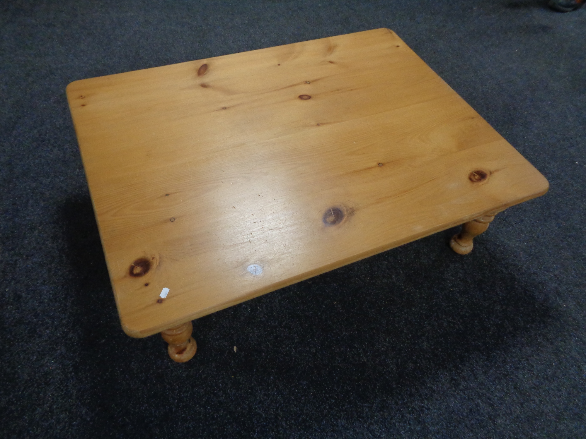 A rectangular pine low coffee table.