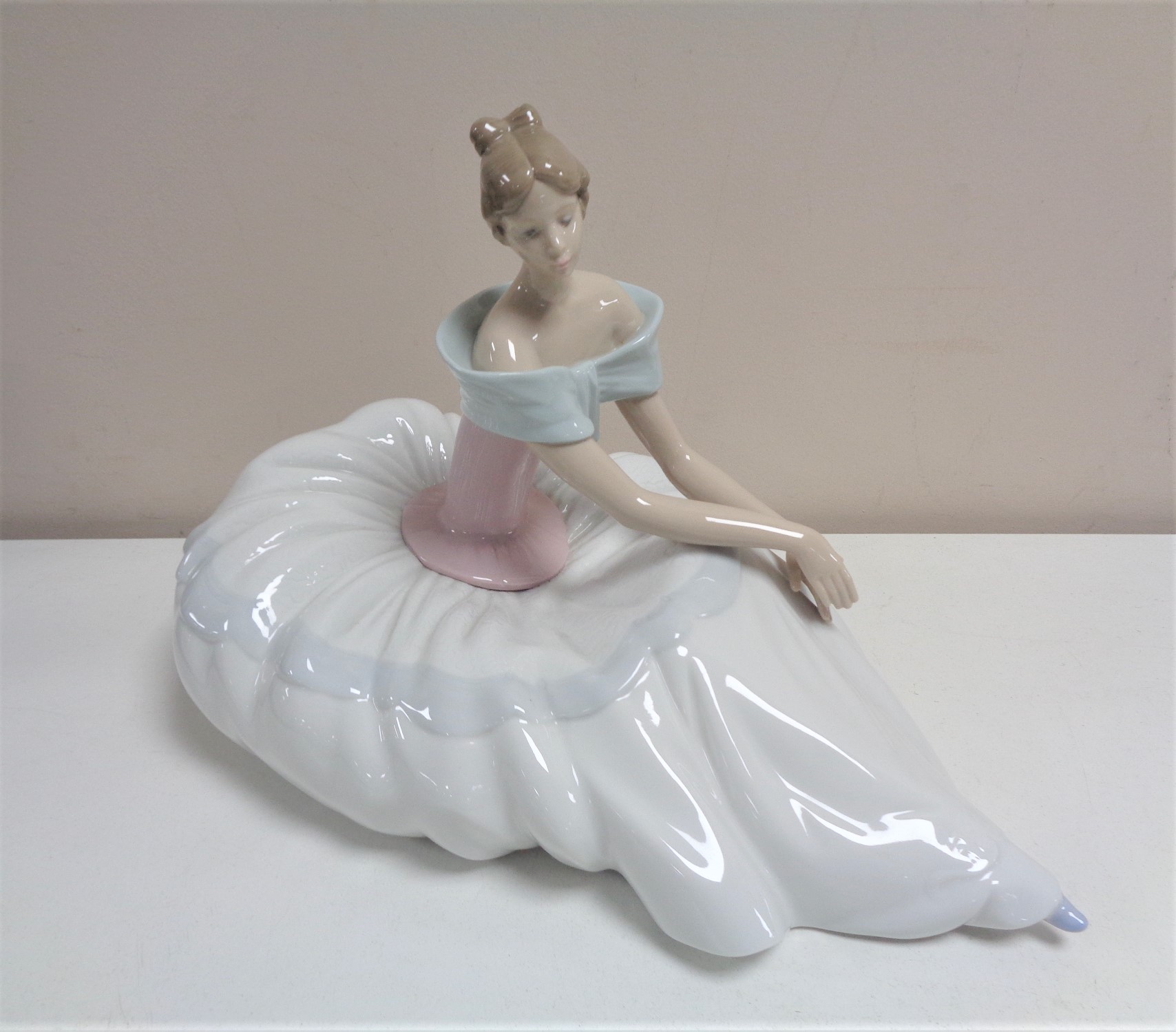 A Nao figure of a Lady seated in flowing dress