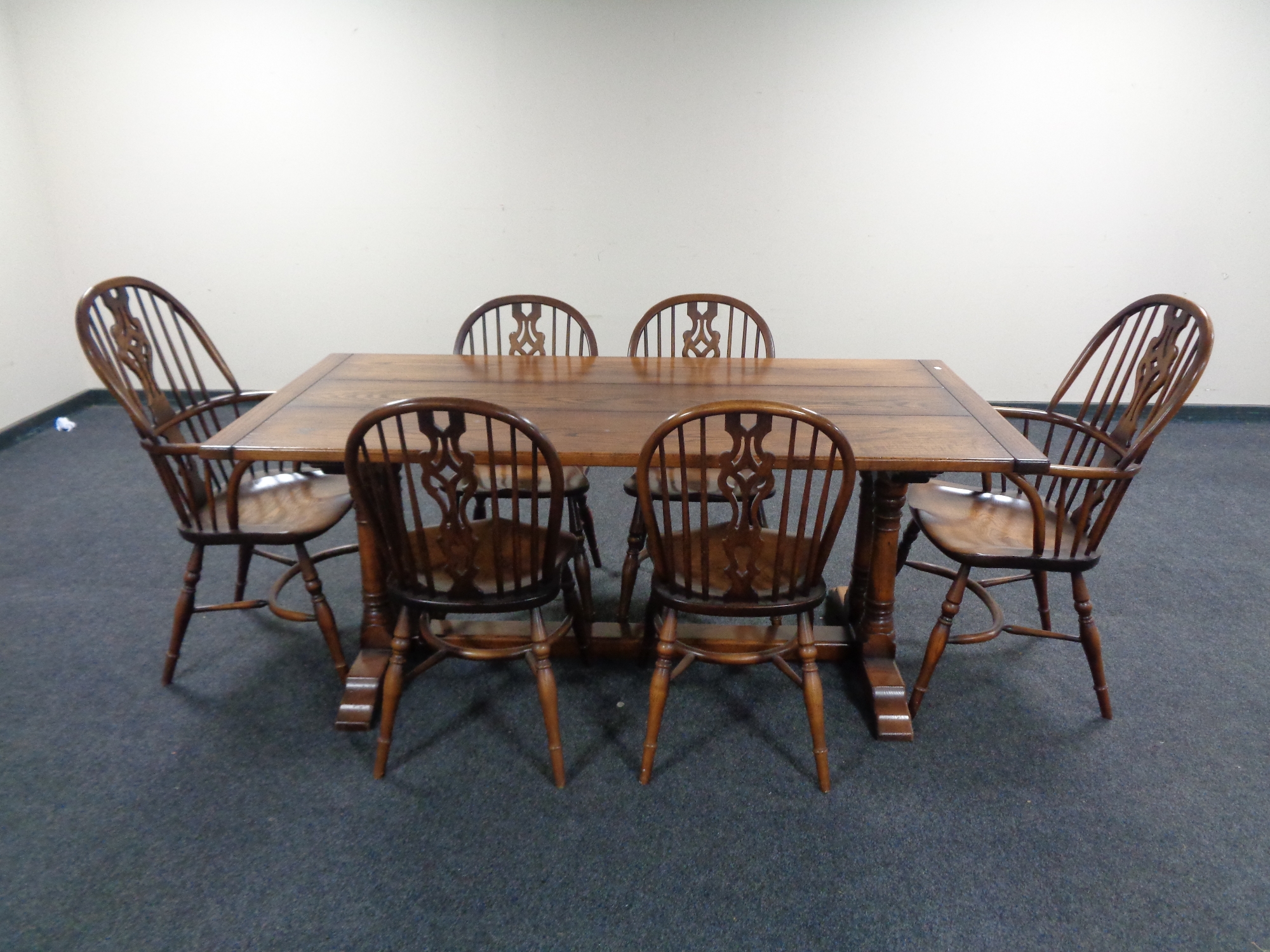 A good quality oak refectory dining table together with a set of six Windsor dining chairs,