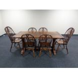 A good quality oak refectory dining table together with a set of six Windsor dining chairs,