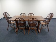 A good quality oak refectory dining table together with a set of six Windsor dining chairs,