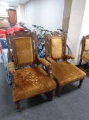 A late 19th century carved oak ladies and gentleman's armchair upholstered in a gold brocade fabric.