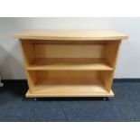 A set of contemporary bow fronted bookshelves in a pine finish.