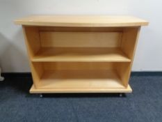 A set of contemporary bow fronted bookshelves in a pine finish.