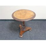 A Victorian inlaid mahogany and walnut pedestal occasional table on bun feet.