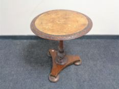 A Victorian inlaid mahogany and walnut pedestal occasional table on bun feet.