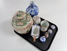 A tray of antique and later Oriental wares, wicker handled blue and white jug (a/f), ginger jar,