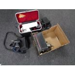 A box containing a cased Pentax ME Super camera with lens, a set of cased Hawland West headphones,