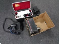 A box containing a cased Pentax ME Super camera with lens, a set of cased Hawland West headphones,