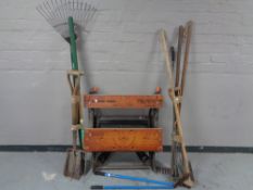 A folding Black and Decker work bench together with a quantity of assorted garden tools.