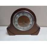 An oak cased 1930's mantel clock with pendulum and key