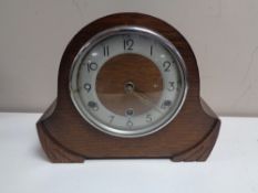 An oak cased 1930's mantel clock with pendulum and key