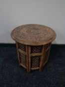 A carved eastern hardwood folding table.