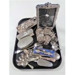 A tray containing antique and later plated wares to include photo frame, toast rack, sugar sifter,