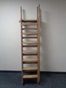 A set of 20th century wooden extension ladders.